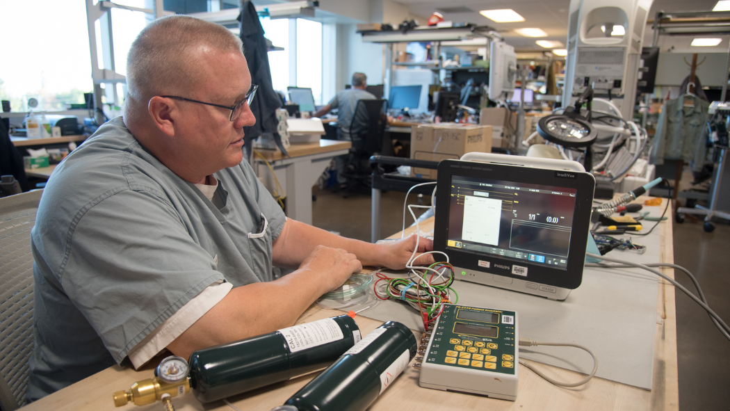 technologist works on a monitor