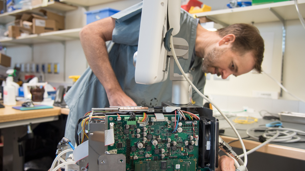 technologist works on machine