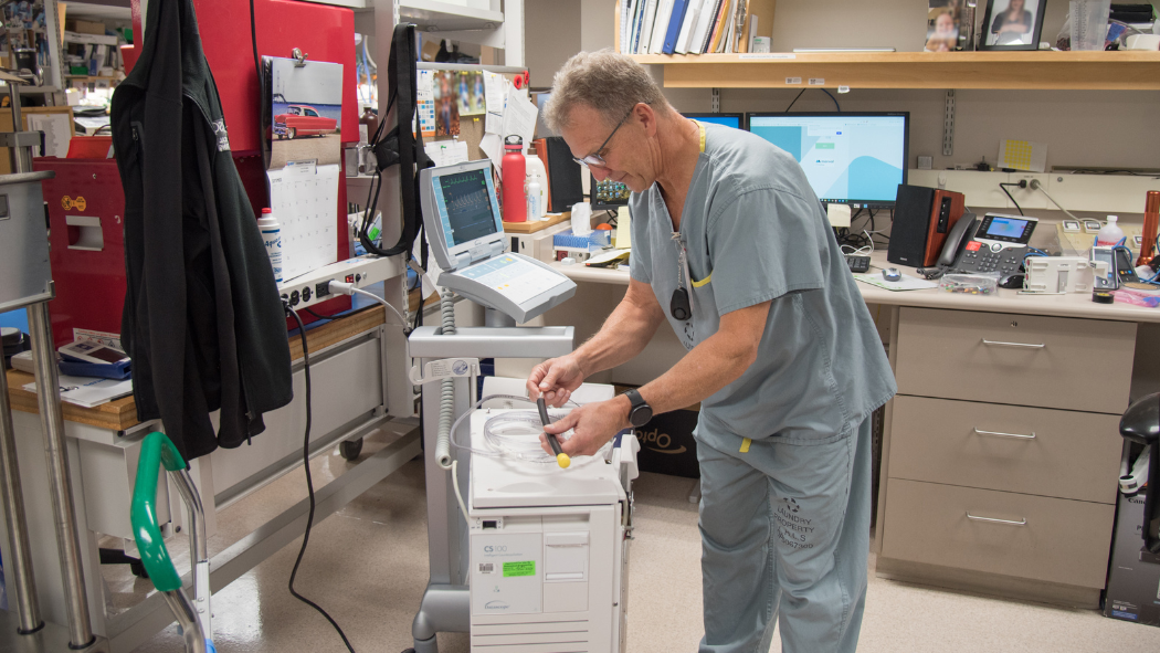 Technologist works on cardiac machine