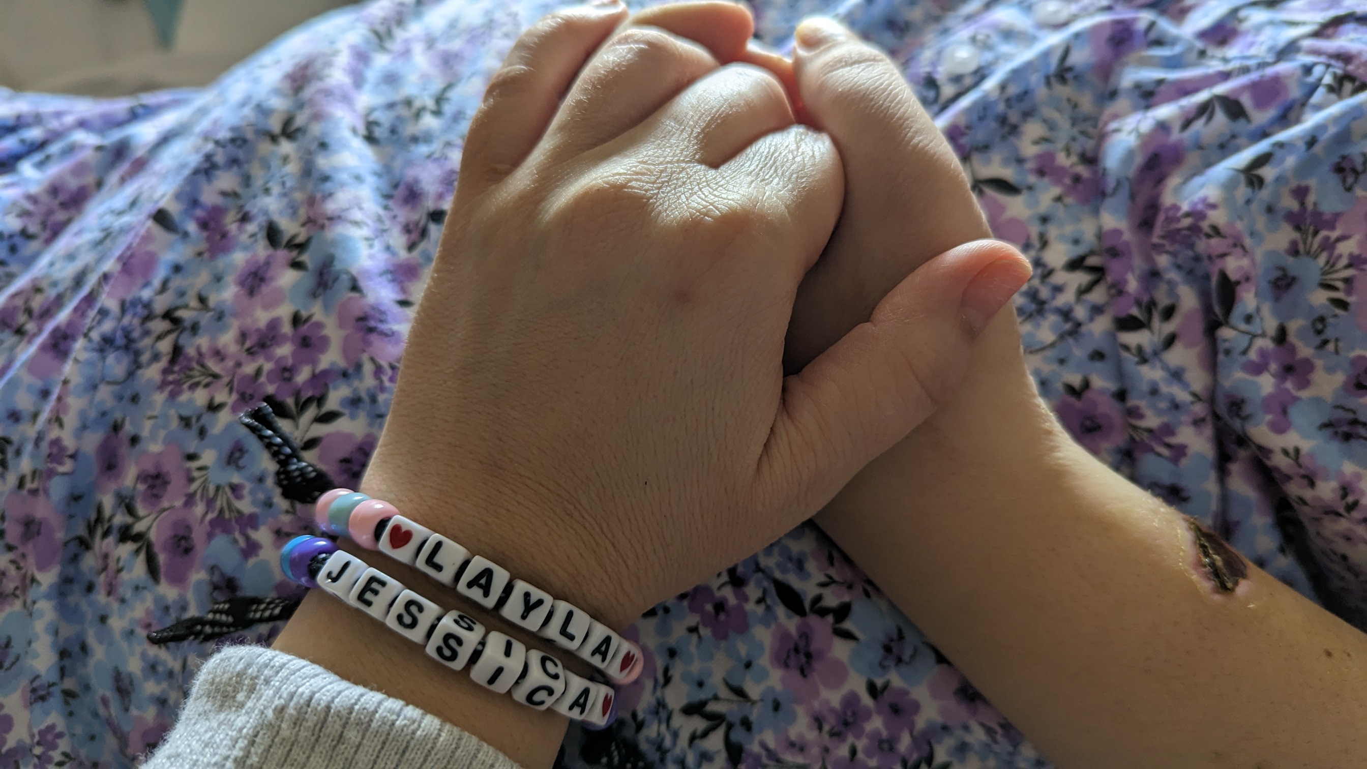 Jessica and Layla hold hands.