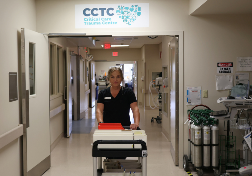 Porter delivers cart of supplies in Critical Care Trauma Centre