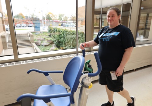 Porter delivers wheelchair to patient