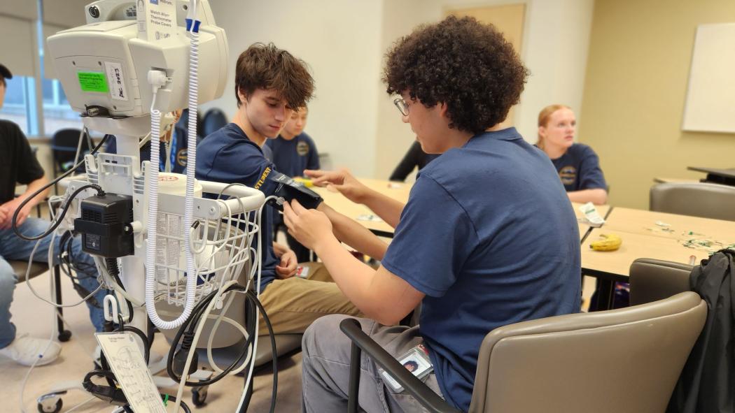 Students practice how to take blood pressure.