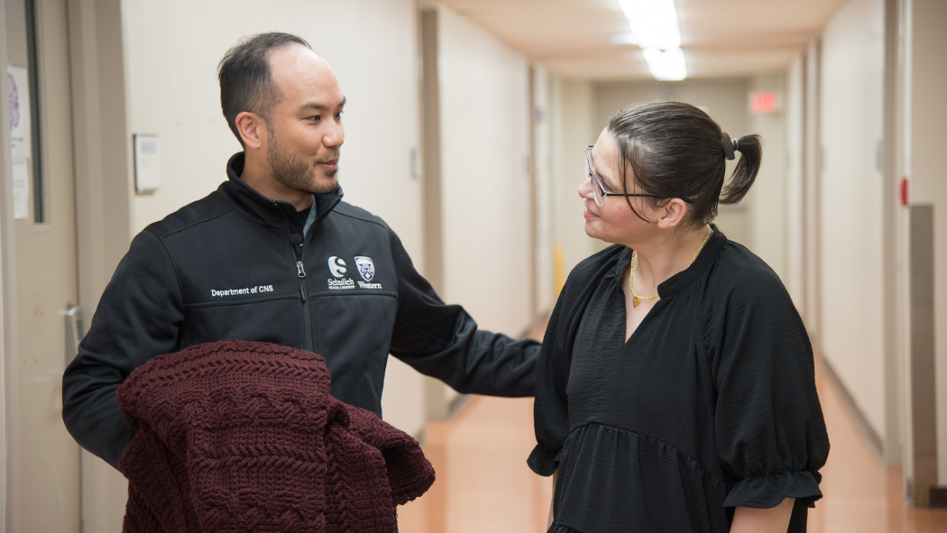 Dr. Lau accepting a blanket from Mandy